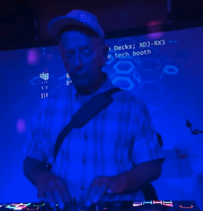 Vinny DJing at NextDoor Club in Honolulu, lit by deep blue stage lights. Vinny DJing at NextDoor Club in Honolulu, lit by deep blue stage lights.