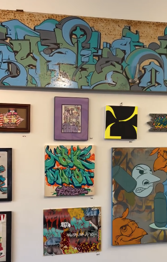 A tribute wall—exploring street art, softness, and the fire of iteration Gallery-style wall filled with colorful, diverse artworks in various sizes